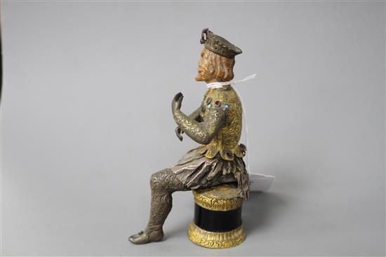 An Austro-Hungarian gilt and white metal figure of a seated knight, with jewelled decoration and hardwood head, height 11.5cm
